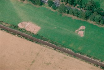 Oblique aerial view centred on the excavation of the pit-defined enclosure at Dunragit, taken from the S.