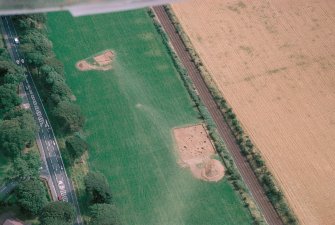 Oblique aerial view centred on the excavation of the pit-defined enclosure at Dunragit, taken from the NW.