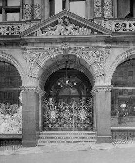 Detail of entrance doorway showing carved stonework and wrought iron gates. Jenners, Princes Street, Edinburgh.