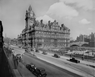 View from north west of the North British Station Hotel also showing Waverley Gardens, the North Bridge, Calton Hill, Waterloo Place and cars parked on the street.