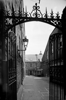 General view of Tweeddale House looking South through Tweeddale Court with wrought iron gates in foreground