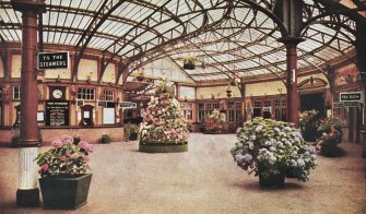 Coloured postcard view of interior of Wemyss Bay station.