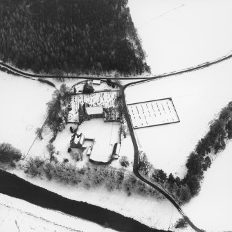 Oblique aerial view of Strathdon Parish Church in the snow, from North North-East.
