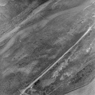 West Mains, oblique aerial view, taken from the SSW, centred on the Border-Crawford-Inveresk Roman Road and quarry pits. Digital image of C/55166.