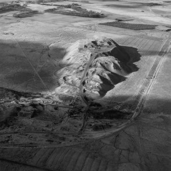 Tarbrax Shale-Oil Works and Viewfield Shale Pit, oblique aerial view, taken from the E, showing the massive bing of the shale-oil mine in the centre of the photograph, between a tramway, on the left, and the Tarbrax Branch of the Caledonian Railway on the right. Viewfield shale-oil mine is visible in the top right-hand corner.