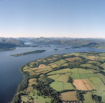 Oblique aerial view looking across Loch Lomond towards Ben Lomond and the Grampian Mountains, taken from the SE.