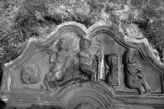 Detail of gravestone 'Iain Laidlaw d.1739' (Laidlaw). Showing Tympanum with a skull, hourglass and three figures holding a mallet, scythe and skull (?)