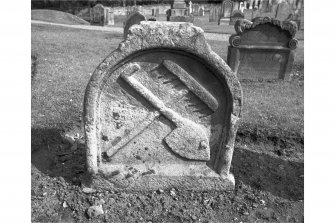 View from W of gravestone commemorating W B and M G d.1657; rake and shovel crossed.