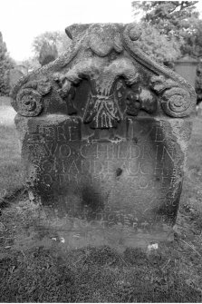 Bolton churchyard.
James and Margaret Troter d.1700 & 1699. East face; tympanum filled by female figure wielding skull and bone. Inscription panel below.