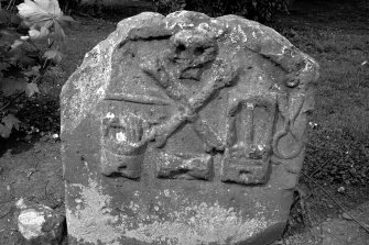 Kelso Parish Churchyard.
Gravestone commemorating Andrew Pateson, d.1704. Rear face showing tools of the dyers trade beneath emblems of mortality.