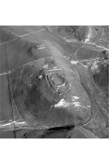 Scanned image of an  oblique aerial view, taken from the WSW, centred on a fort and settlement site, with Nisbet settlement site and cultivation terraces to the top of the photograph.