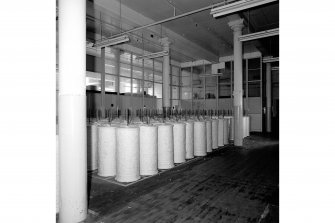 Paisley, Ferguslie Thread Mills, Mill No.1, 1st Flat; Interior
View of rolls of cleaned cotton waiting to be taken to carding machines, W end of 1st flat