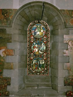 Interior. North chapel, stained glass window on north wall showing scenes from the life of Christ.