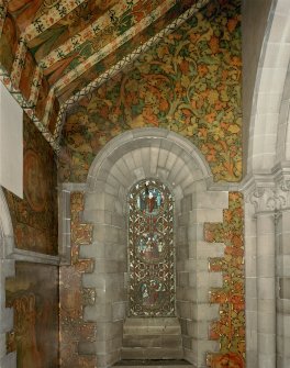 Interior. North chapel, view of mural on east wall and stained glass window.