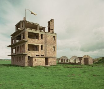 Fearn Airfield Naval Control Tower, view from S showing S and W elevations of tower and Nissen hut to rear.