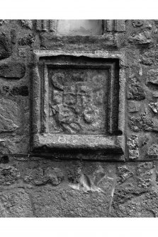 View from courtyard of armorial panel and inscribed lintel in North East range