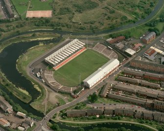 Maryhill, oblique aerial view, centred on Firhill Park and the Forth and Clyde Canal.