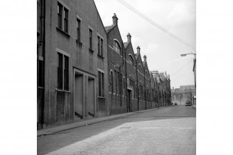 Glasgow, 25-39 Rowchester Street, Whitevale Tram Depot
View from S showing ESE front (David Street front) with St Nicholas Roman Catholic Church in foreground