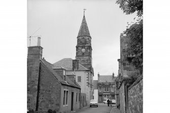 Falkland, High Street, Town Hall
View from SE showing SSE front of Town Hall steeple with cottage in foreground and post office in background