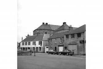 Cupar, East Burnside, Burnside Mills
View from W showing NNW front of public house with house and garage in foreground and roofs of kilns in background
