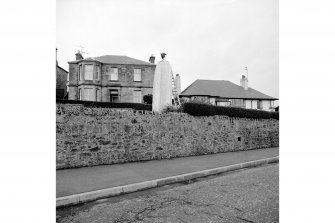 Fife, Crail, Upper Leading Light
View. This pair of leading lights was constructed to guide vessels along a safe channel to the entrance to Crail Harbour. This view shows the upper of the two lights, situated in a small landscaped area above the main road through Crail. The street-lamp-style lantern is evident. By 1979 ith lamp itself was electrically lit.

