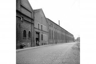 View from W showing SSW front of warehouse (after it became part of forge) with part of forge on right and left