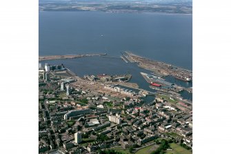 Scanned image of colour photograph, oblique aerial view, taken from the SSE, centred on Leith Docks with North Leith in the bottom half.