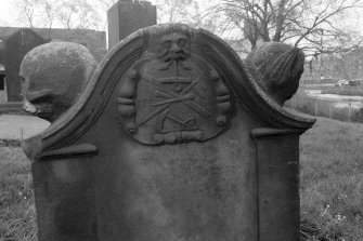 North Leith Burial Ground.
View of gravestone, Home, green man holds anchor in mouth, heads on shoulders of headstone.
