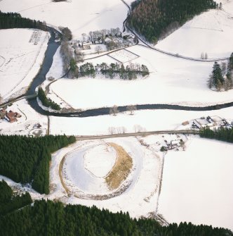 Oblique aerial view of Strathdon Parish Church and Doune of Invernochty in the snow, from West North-West.