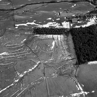 Calf Knowe, oblique aerial view, taken from the NW, centred on ring-enclosures and huts.