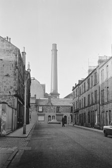 View from ESE showing chimney of brewery with part of numbers 2-40 Glebe Street, 11-29 and 14-20  Melville Street in foreground