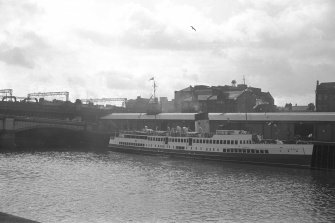 View from NW showing Queen Mary II at Bridge Wharf with part of George the Fifth Bridge on left