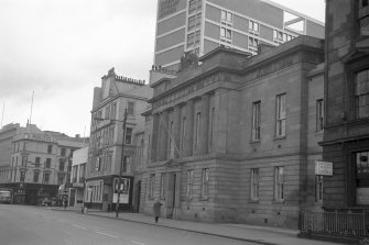 View from SSE showing SW front of Custom House with public house in background