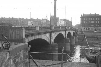 View from NNE showing WNW front of bridge with tenement and distillery in background