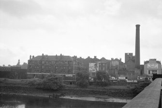 View from N showing NE front of distillery and NE front of tenements