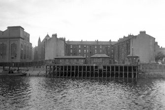 View from NE showing NE front of pier with tenements and part of platers shed in background