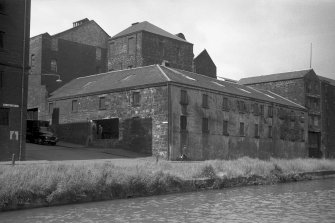 View from SW showing WSW and SSE fronts of S (central) bonded store with distillery buildings in background