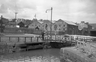 View from SW showing WSW front of bridge with bonded warehouse in background