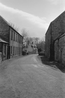 View looking SSE showing cottage with old building on right and E block on left