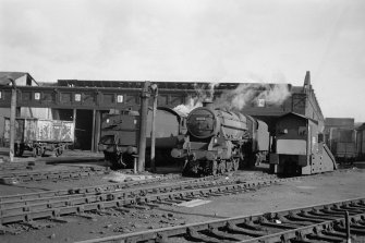 View showing steam engines, including Stanier 5MT 45016, in front of depot.