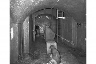 Tank access tunnel, view of tank end showing float gauge, winch and access ladder.