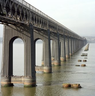 Detailed view of the Tay Railway Bridge, Dundee, from SE of the steel piers and girders forming the south end of the bridge, with the foundations of the earlier bridge visible (right).