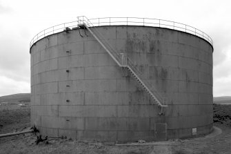 View of circular oil storage tank from East