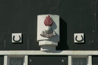 Detail of crest with motto above central first floor window.