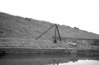 View from WSW showing derrick crane with part of canal wharf in foreground