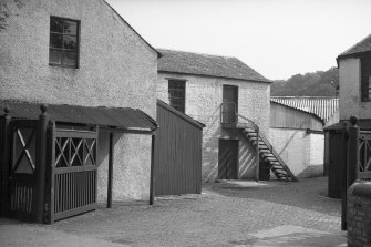 View looking ENE through entrance gate to mills