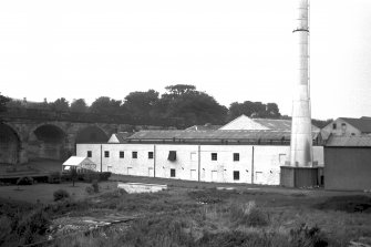 View from S showing SW front of S block of works with viaduct in background
