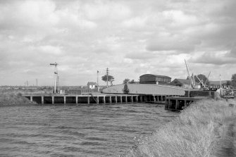 View from W showing NNW front of swing bridge with workshops in background and part of sea lock in foreground