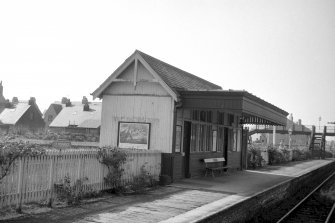 View from NNE showing NE and NW fronts of up platform building with wood footbridge in background