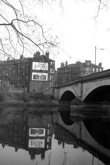 View from WSW showing part of NW front of bridge with tenements in background